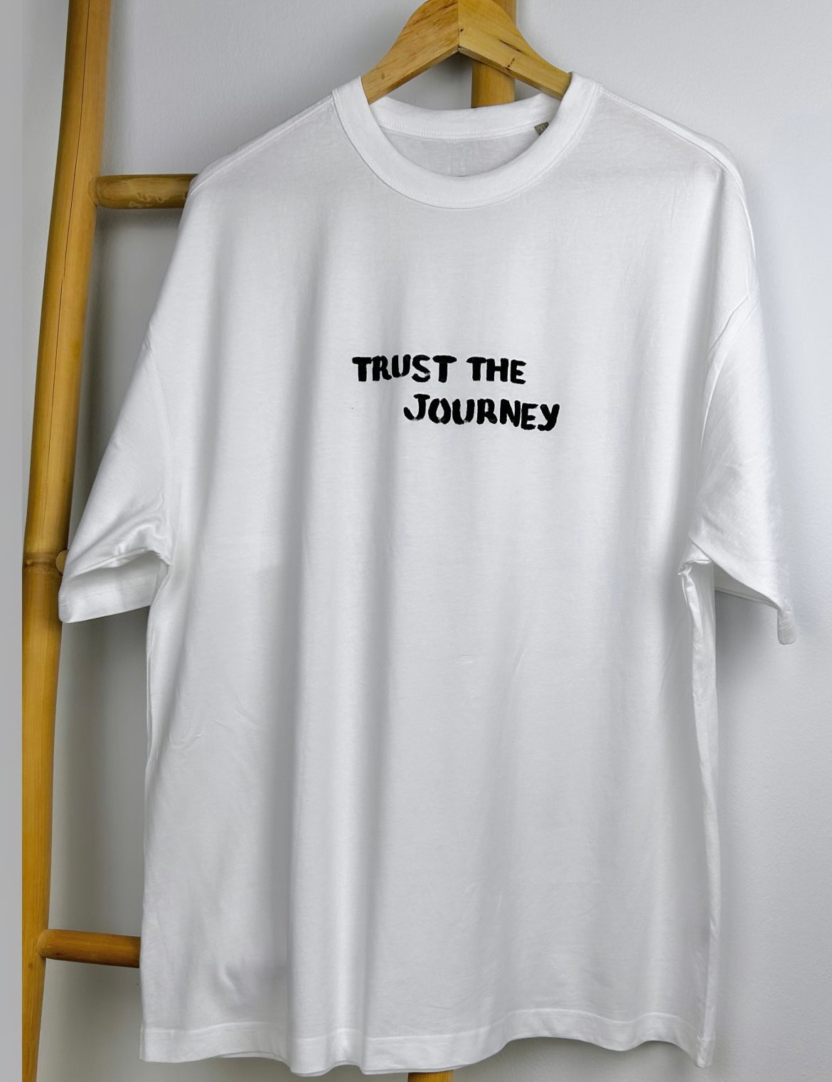 White oversized unisex handpainted T-shirt - “Trust the journey”